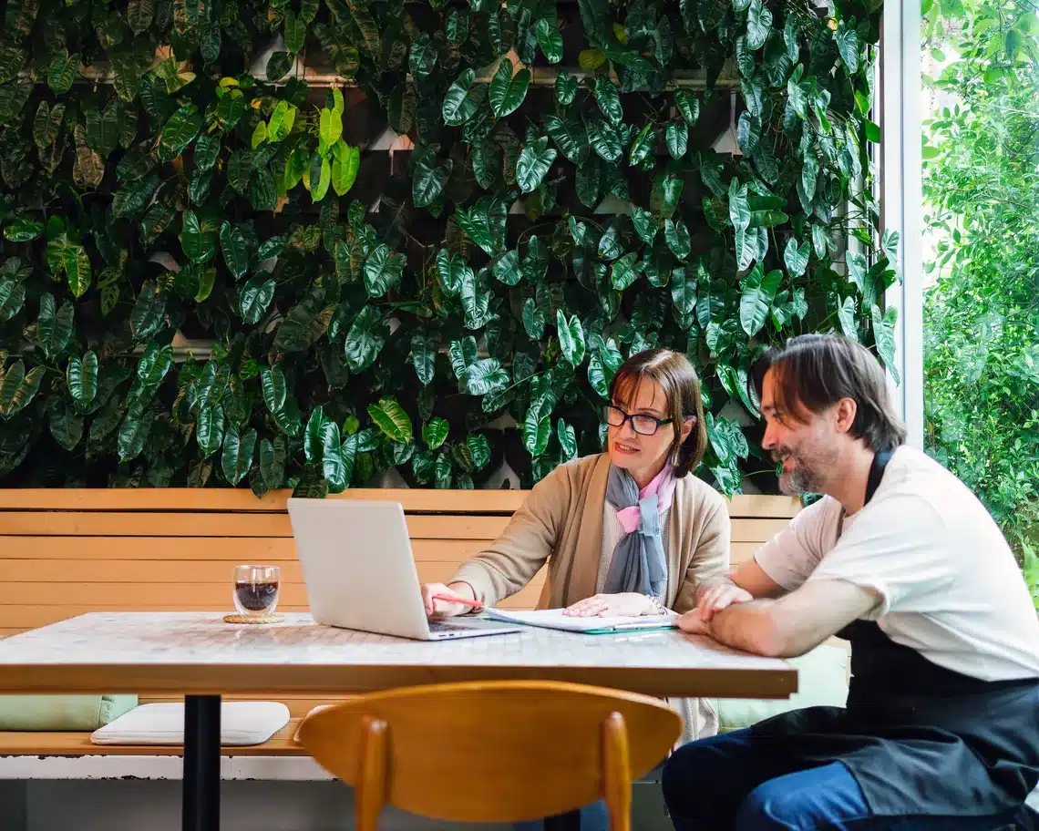 Consultant reviewing results with cafe owner