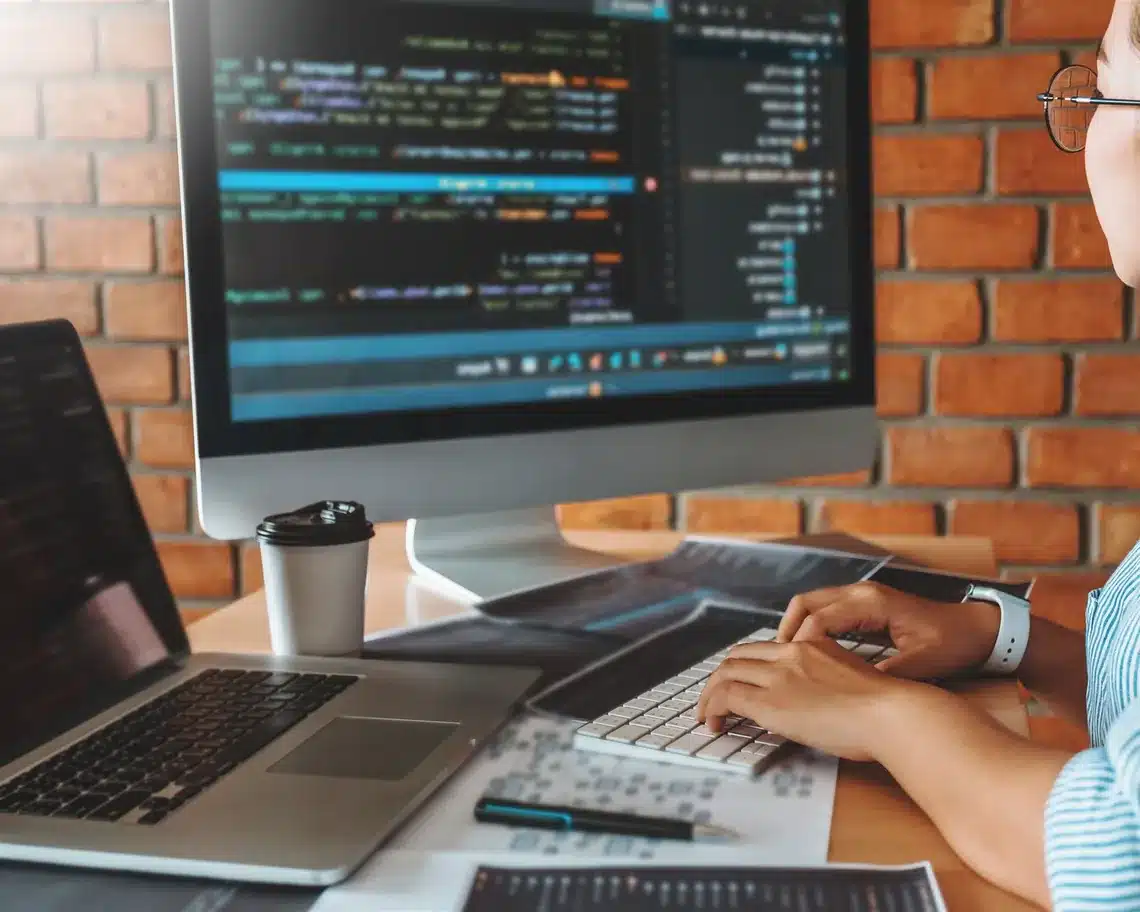 Web developer updating website code at desk